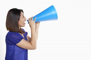 Woman shouting into a megaphone